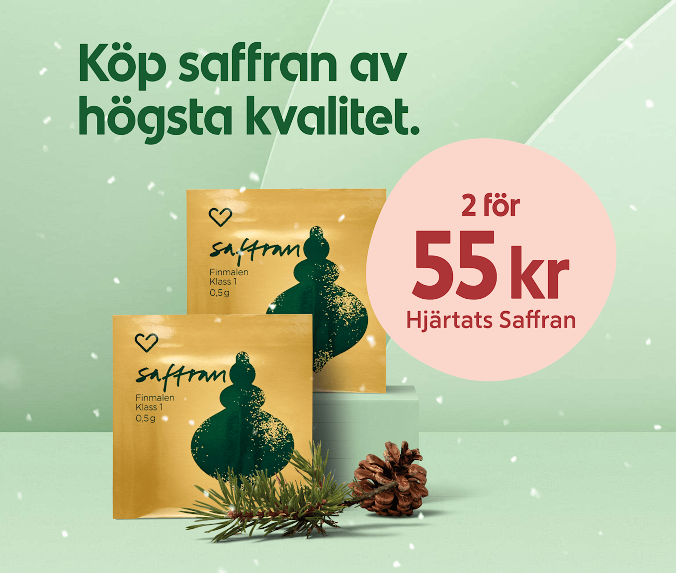 Gröna och guldfärgade saffransförpackningar framför mintgrön bakgrund med texten "Köp saffran av högsta kvalitet" och en rosa cirkel med erbjudandet "2 för 55 kr Hjärtats Saffran", granris och kottar i förgrunden.