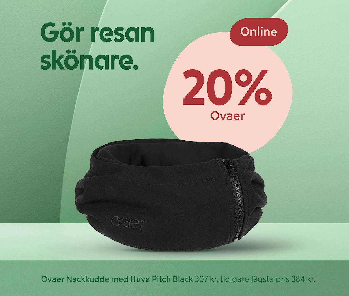 Svart uppblåsbar nackkudde med inbyggd huva och synlig dragkedja placerad på en grön scen, texten "20% Ovaer" i rosa cirkel och slogan "Gör resan skönare." i bakgrunden.